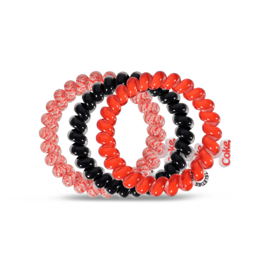 Coca Cola Teleties are a unique brand of hair ties, made with a patented material that holds your ponytail firmly and securely. The material is soft and won't tug or pull at your hair, making them gentle enough for all hair types. Their Coca Cola-branded colors and designs give you a fashionable and stylish way to accessorize any look.