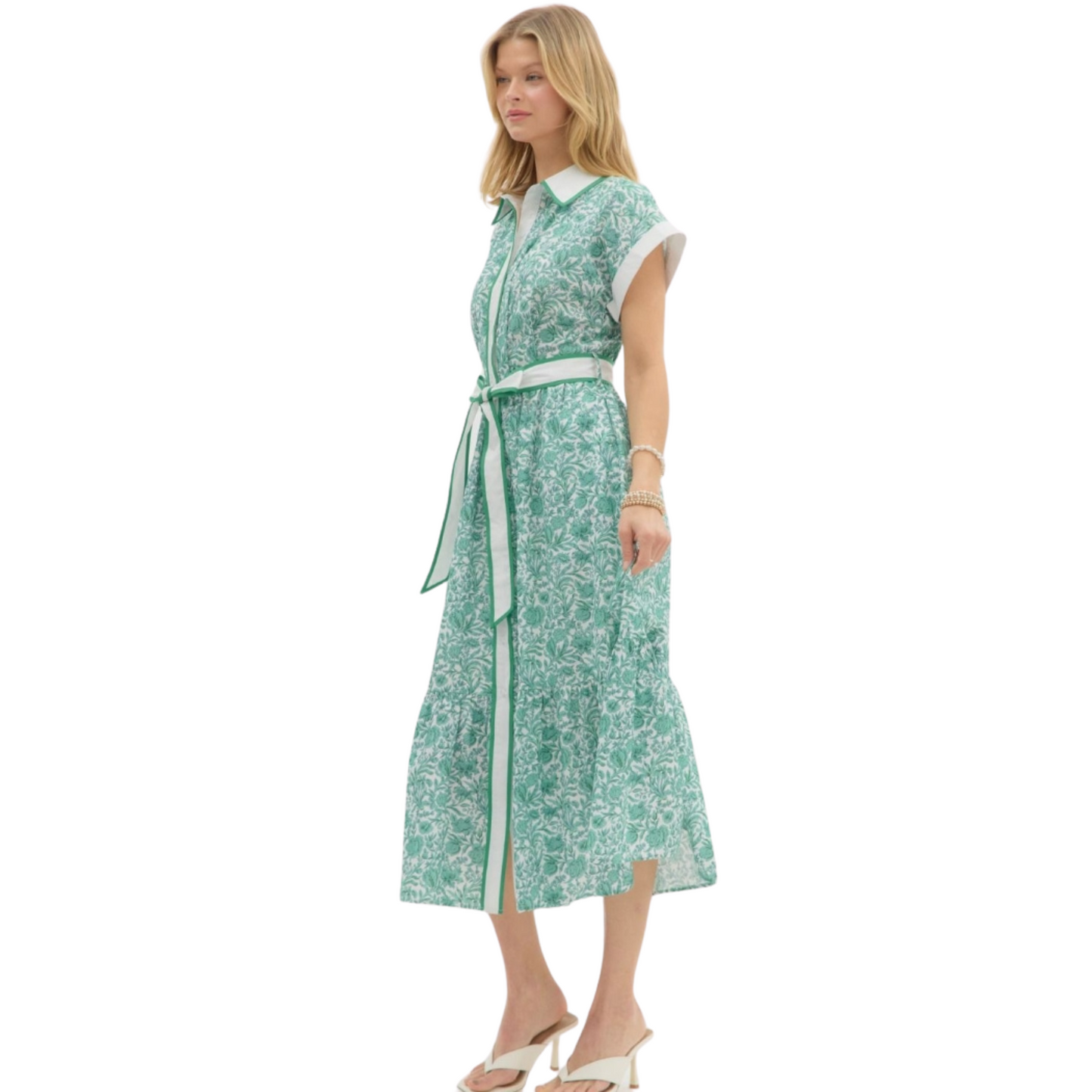 This floral midi shirtdress by Entro is both classy and sophisticated. Featuring a collared neckline, a green and white floral print, short sleeves, and a tie waist, this dress is perfect for any occasion. Stay stylish and comfortable with this versatile piece.