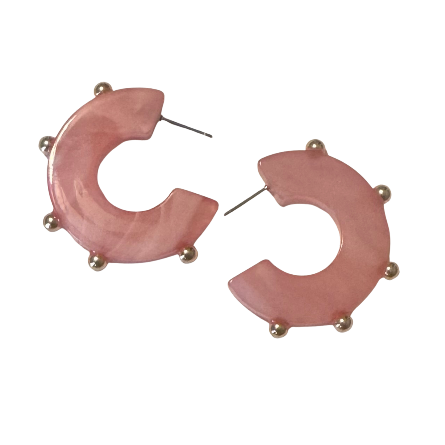 Perdido Gems presents these striking acrylic hoop earrings, featuring a soft pink base elevated by gleaming gold accents. The lightweight construction makes them comfortable for extended wear, while the bold hoop silhouette delivers contemporary style. Perfect for layering or wearing solo, these versatile pieces transition seamlessly from day to evening. A modern essential that combines playful color with sophisticated metallic detailing.