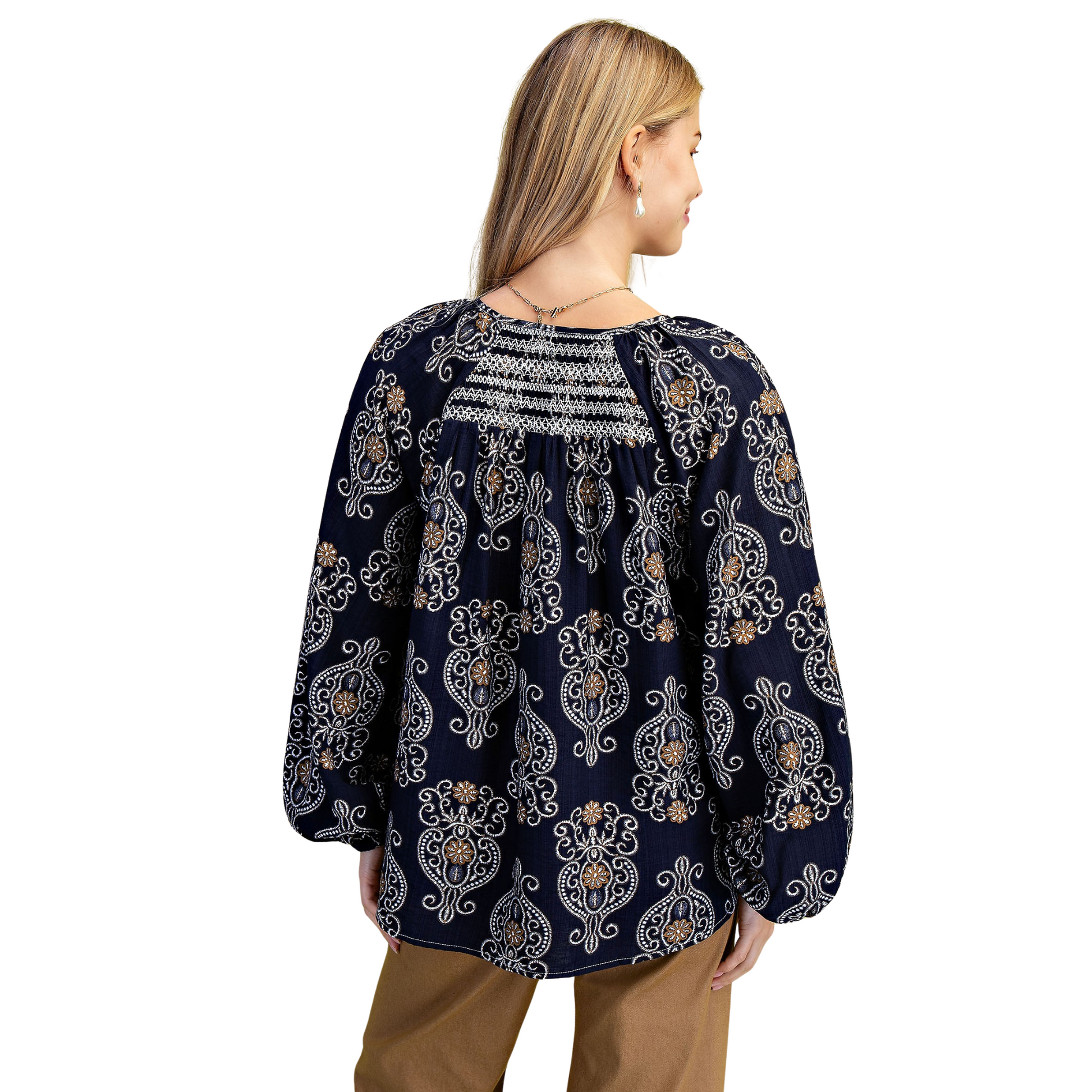 Elevate your wardrobe with the GiGio Balloon Sleeve Blouse in a sophisticated navy mix. Featuring a flattering v-neck and long sleeves, this blouse showcases decorative smocking on both front and back for subtle texture and refined detail. Its tailored design combines comfort with stylish elegance, making it an ideal choice for professional or upscale casual settings.
