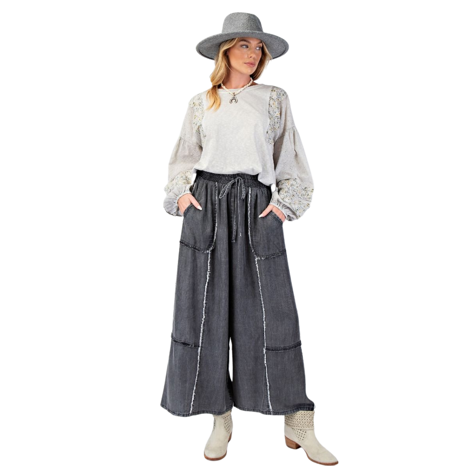 Update your wardrobe with our Chambray Palazzo Pants! These washed denim pants offer a relaxed and loose fit, perfect for a comfortable and stylish look. The smocked waistband with an adjustable tie provides a flattering silhouette while the frayed panel detailing adds a touch of uniqueness. With functional front pockets and a wide leg design, these pants are both practical and chic. Available in regular and plus size. 