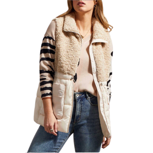 Stay warm and stylish with our Sleeveless Sherpa Combo Vest. Lightweight yet cozy, this zip-up vest features a bone color design with a tribal brand. The soft fabric provides insulation to keep you comfortable without feeling weighed down.