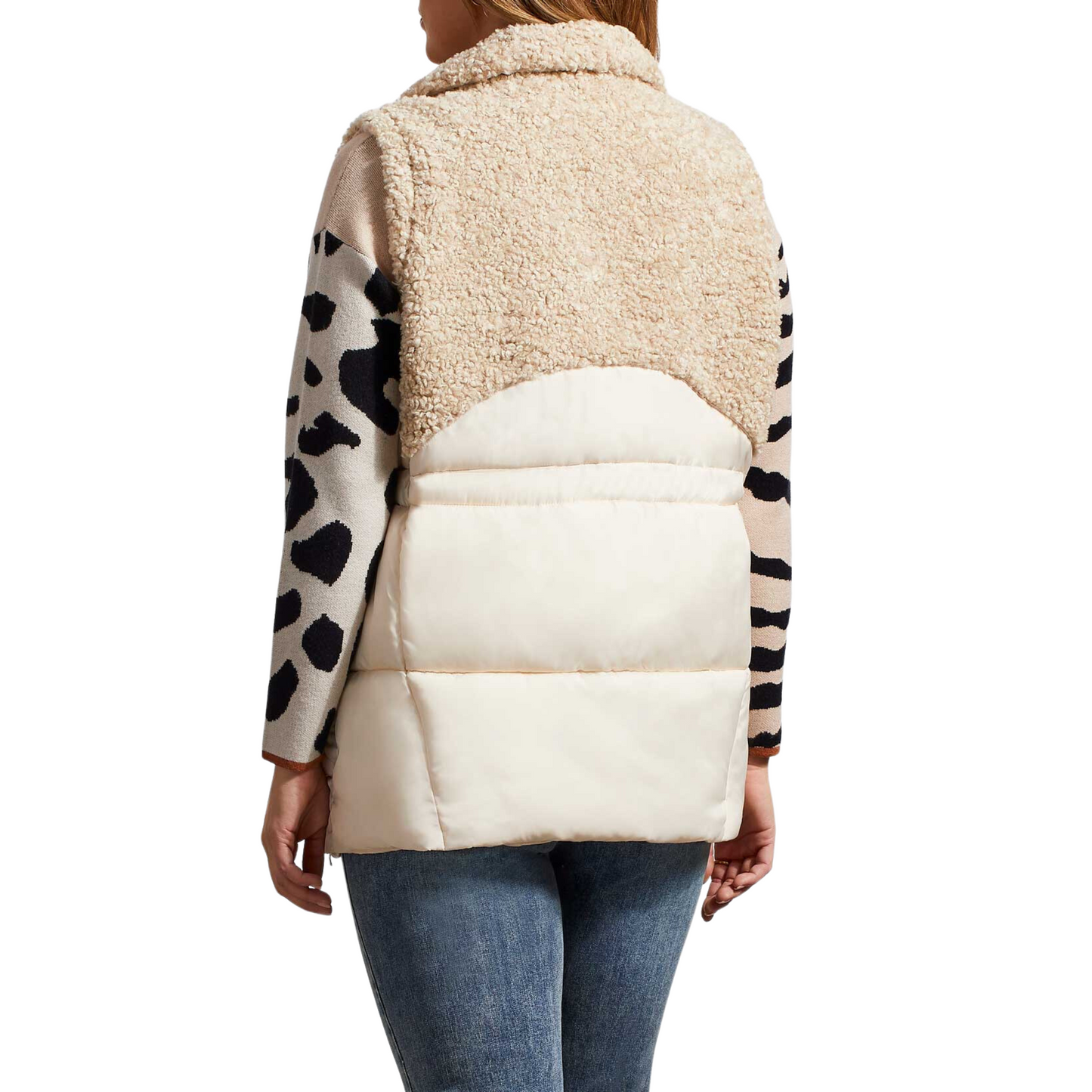 Stay warm and stylish with our Sleeveless Sherpa Combo Vest. Lightweight yet cozy, this zip-up vest features a bone color design with a tribal brand. The soft fabric provides insulation to keep you comfortable without feeling weighed down.