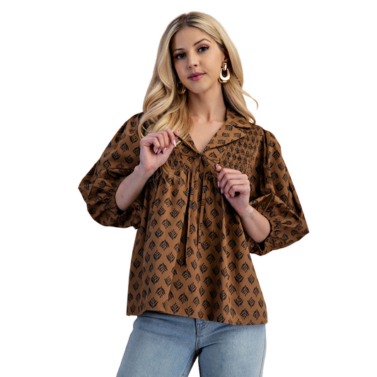 This GiGio Printed Front Tie Top combines timeless style with contemporary details. Featuring a flattering brown hue and a chic v-neckline, it offers a versatile look for various occasions. The 3/4 length puff sleeves add a touch of volume and sophistication, while the smocking details ensure a comfortable, tailored fit. Perfect for layering or wearing solo, this top balances elegance and ease with expert craftsmanship.