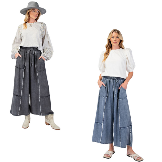 Update your wardrobe with our Chambray Palazzo Pants! These washed denim pants offer a relaxed and loose fit, perfect for a comfortable and stylish look. The smocked waistband with an adjustable tie provides a flattering silhouette while the frayed panel detailing adds a touch of uniqueness. With functional front pockets and a wide leg design, these pants are both practical and chic. Available in regular and plus size. 