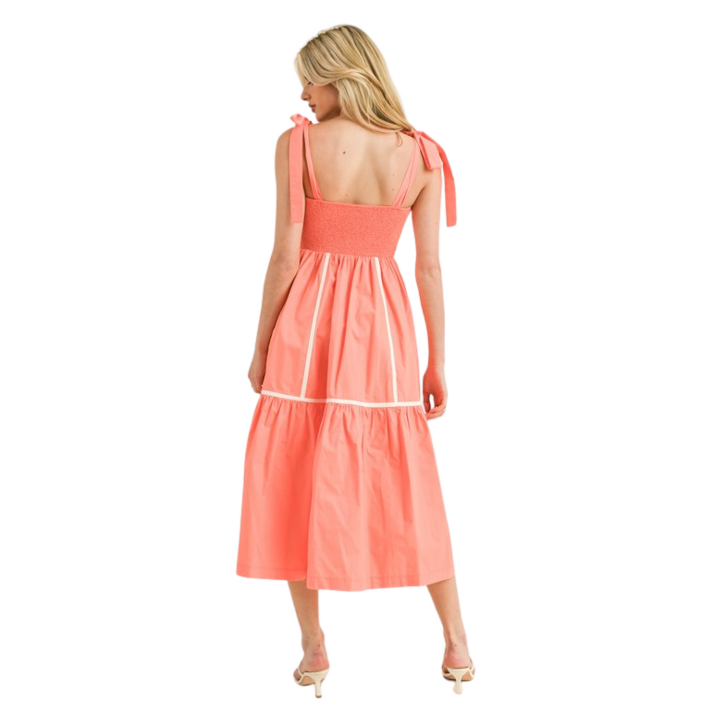 Expertly designed with contrast binding and a square neckline, this midi dress adds a touch of elegance to any occasion. The wide tying straps and smocked back provide a comfortable fit, while the pockets offer convenience. Available in a vibrant coral color, this dress is the perfect combination of style and functionality.