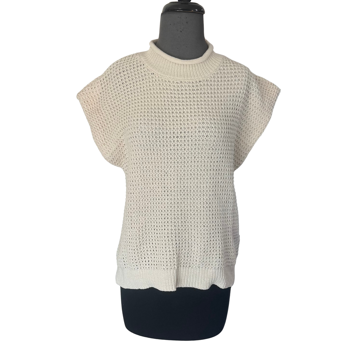 Effortless style meets comfort in this cream-colored short sleeve sweater top from Very J. The loose knit construction offers a relaxed, flattering silhouette perfect for layering or wearing solo. A classic mock neck adds sophistication and warmth, while the breathable fabric keeps you comfortable all day. Ideal for casual outings, work, or cozy weekends. Pair with jeans, trousers, or skirts for a versatile look.