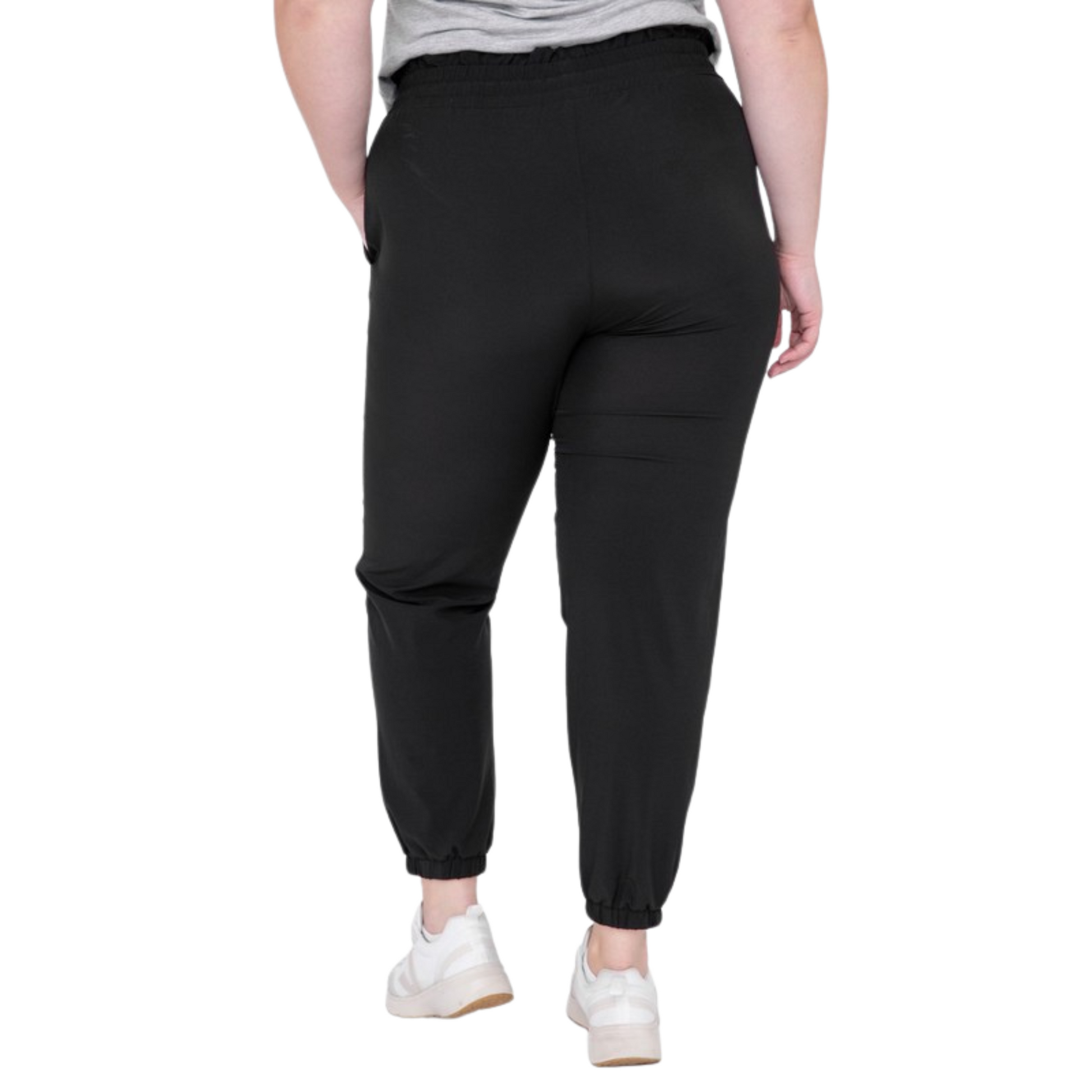 Be ready for your next adventure with these Curvy High Waisted Joggers. Crafted from premium fabric, they feature a high and elasticized waistband with drawstring closure, slanted pockets, and 7/8 length with cuffed ankles for a stylish look. Available in classic black color.