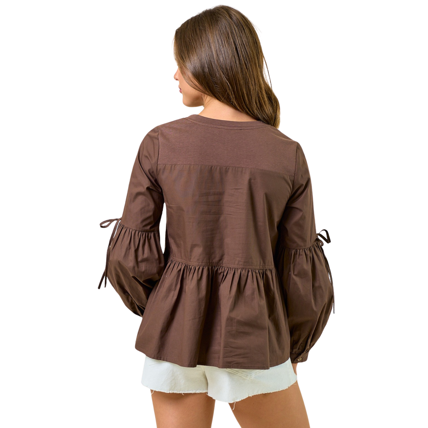 This long sleeve peplum blouse from Doe & Rae features a rich dark brown color that adds warmth and versatility to any wardrobe. Its elegant puff sleeves and classic round neck create a flattering silhouette while maintaining comfort and style. Ideal for both professional and casual settings, this blouse pairs effortlessly with various bottoms, making it a sophisticated choice for the modern woman.