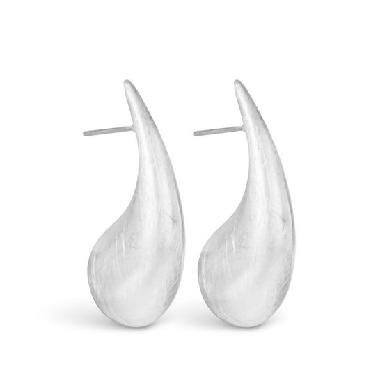 The Nora Droplet Huggie Studs feature a stunning matte silver finish and a unique droplet design. Crafted with high-quality silver, these earrings make a beautiful addition to any jewelry collection. Elevate your style with these versatile and elegant studs.