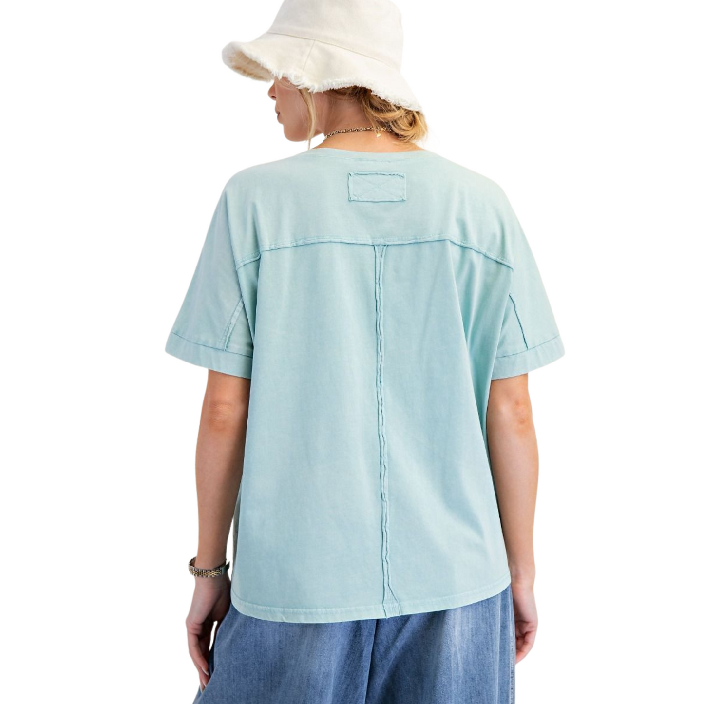 The Mineral Wash Boxy Top by Easel features delicate blue embroidered flowers that add subtle elegance to its laid-back design. Crafted for plus-size comfort, its short sleeves and relaxed boxy fit offer breathability and ease of movement. Ideal for warm days, this top combines soft mineral-washed fabric with expert tailoring to ensure a flattering, comfortable silhouette.