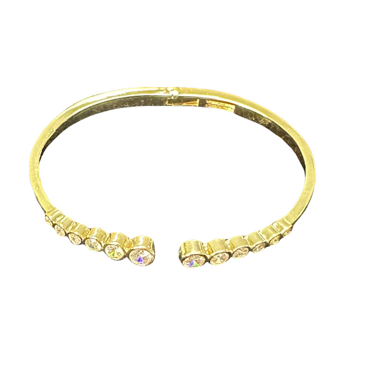 Expertly crafted from luxurious gold, the Empire Rhinestone Bangle boasts stunning rhinestone accents that add a touch of glamour to any ensemble. Its elegant cuff design exudes sophistication, making it the perfect accessory for any occasion. Elevate your style with this must-have piece.