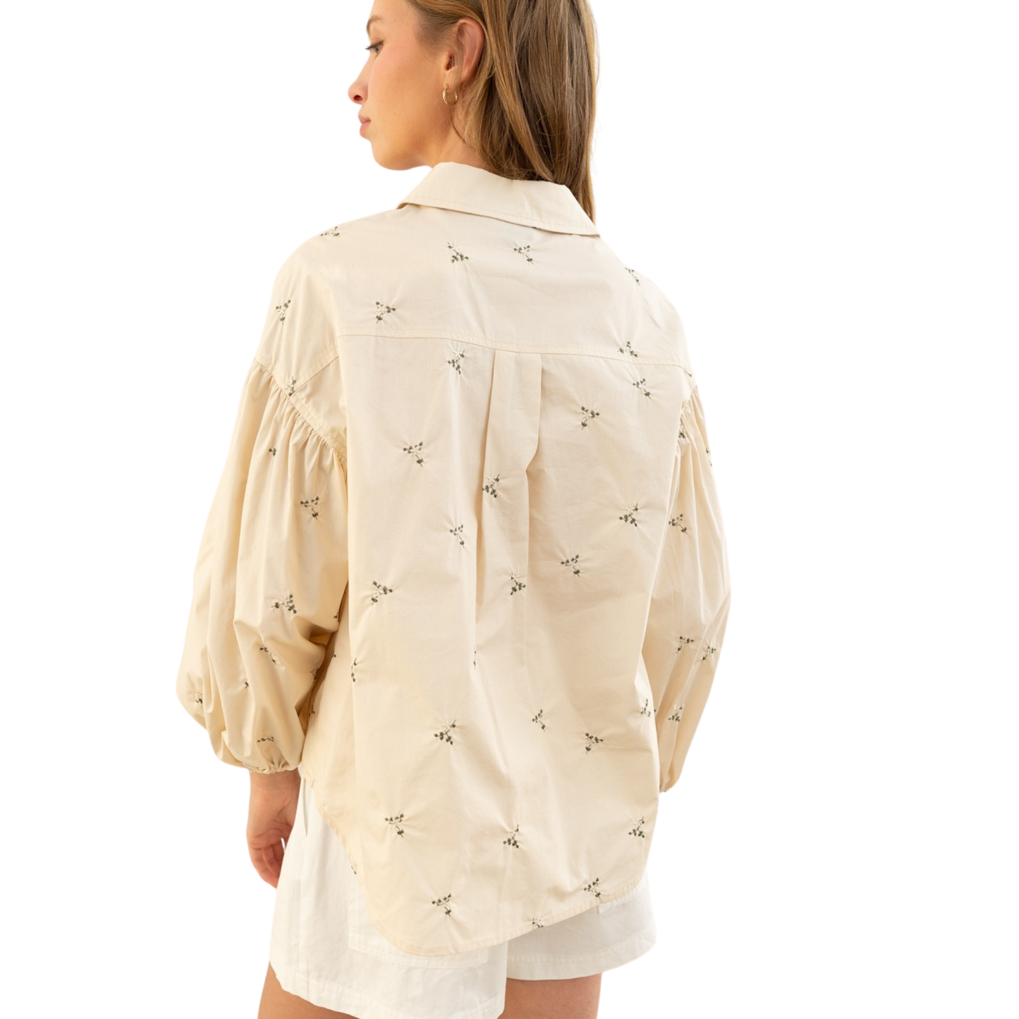 This cream-colored Heyson top features elegant balloon sleeves and a classic button-down design, combining comfort with refined style. Expertly embroidered details add a sophisticated touch, making it a versatile piece perfect for both casual and polished looks. Crafted to offer a flattering fit, this top balances trend and timelessness with ease.