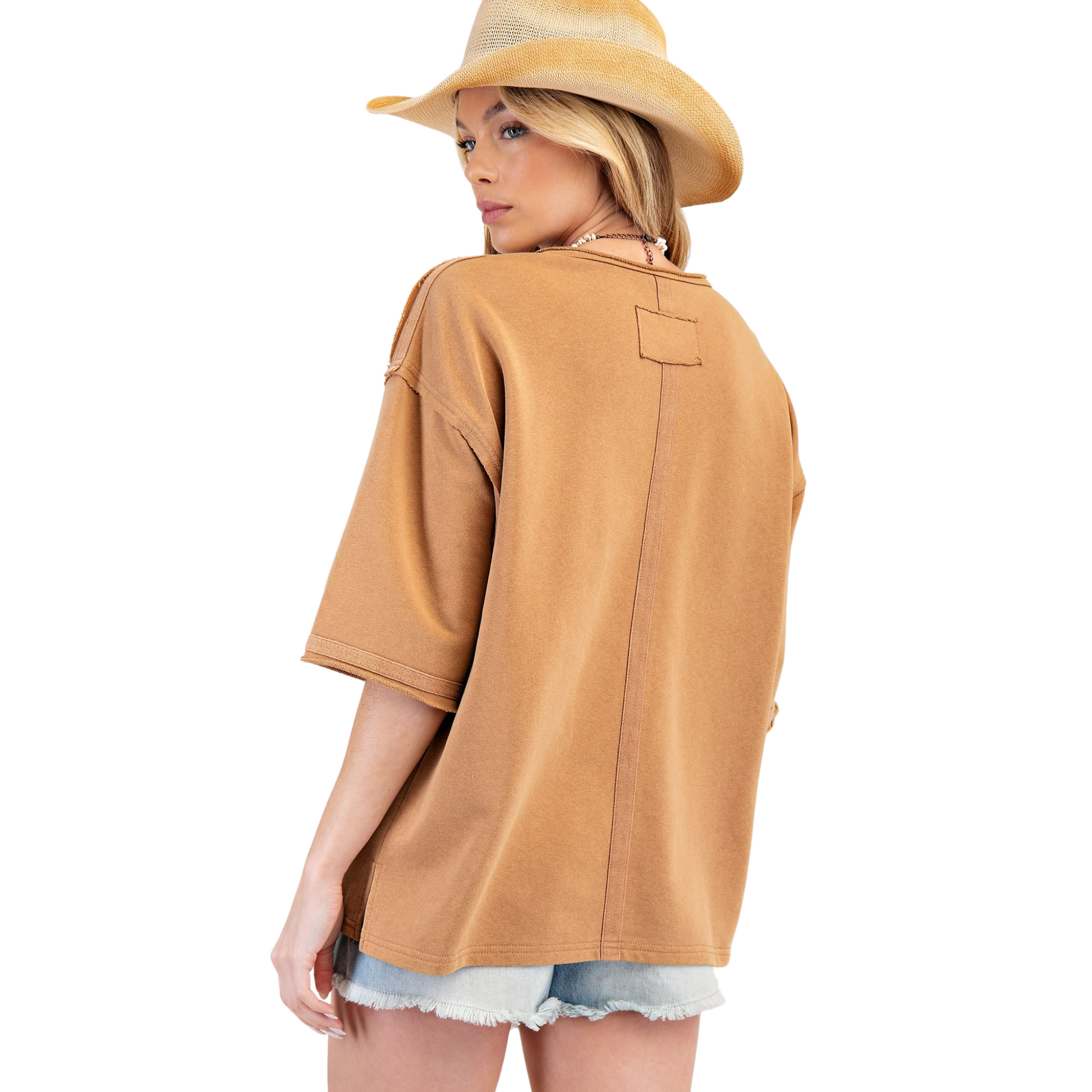 Introducing the Flower Patch Terry Knit Tunic Top, a stylish and comfortable addition to your wardrobe. This almond colored top features intricate flower patches and flattering half sleeves. From the trusted brand Easel, this tunic combines fashion and comfort for a must-have piece.