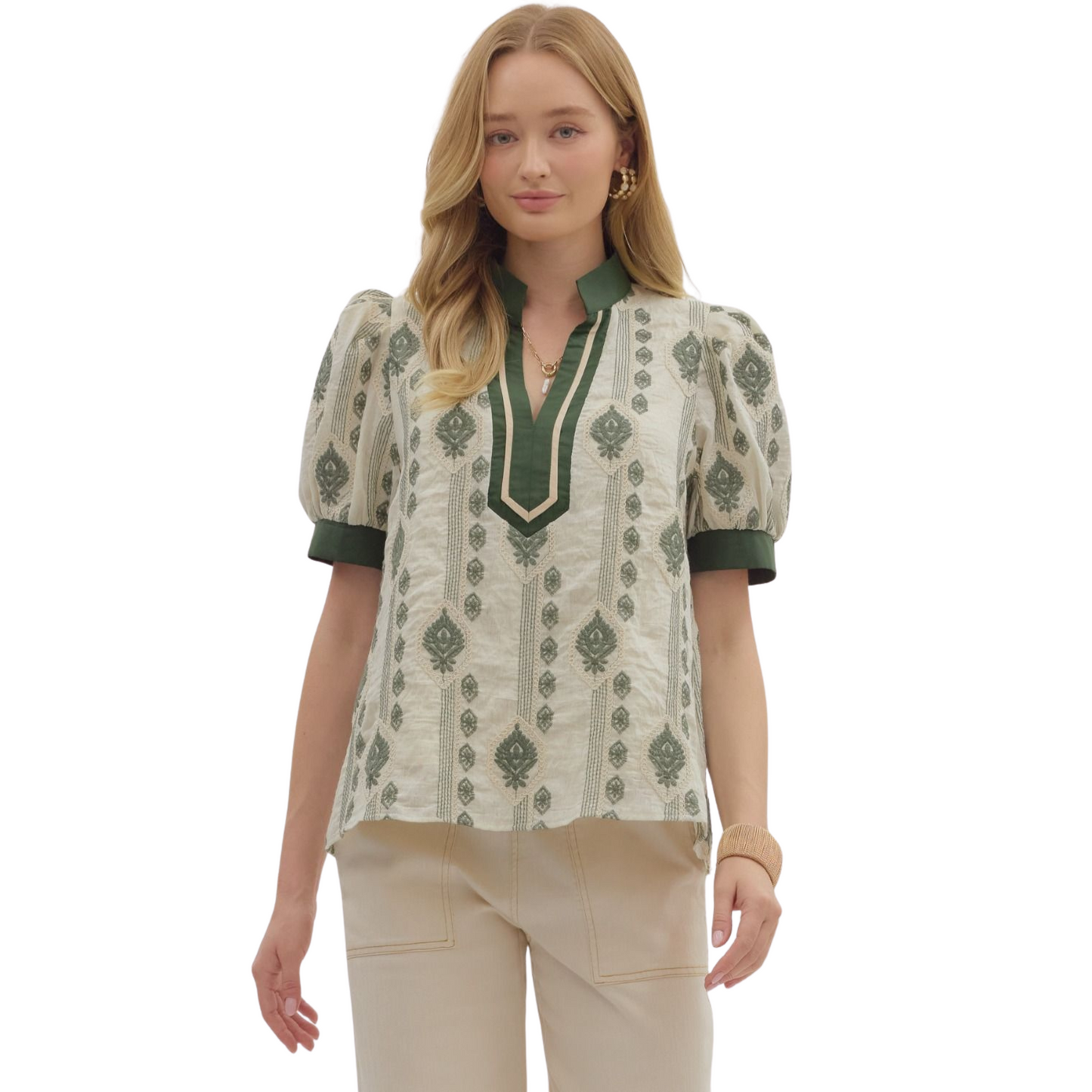 This lightweight woven top showcases an abstract embroidered pattern with short puff sleeves, adding volume and a touch of femininity. Its caftan-inspired neckline with contrasting accents elevates the design, offering a unique focal point. Unlined and non-sheer, it ensures comfortable wear without bulk. Perfect for layering or as a standalone piece, this green top blends artistic detail with breathable fabric for an effortlessly refined look.