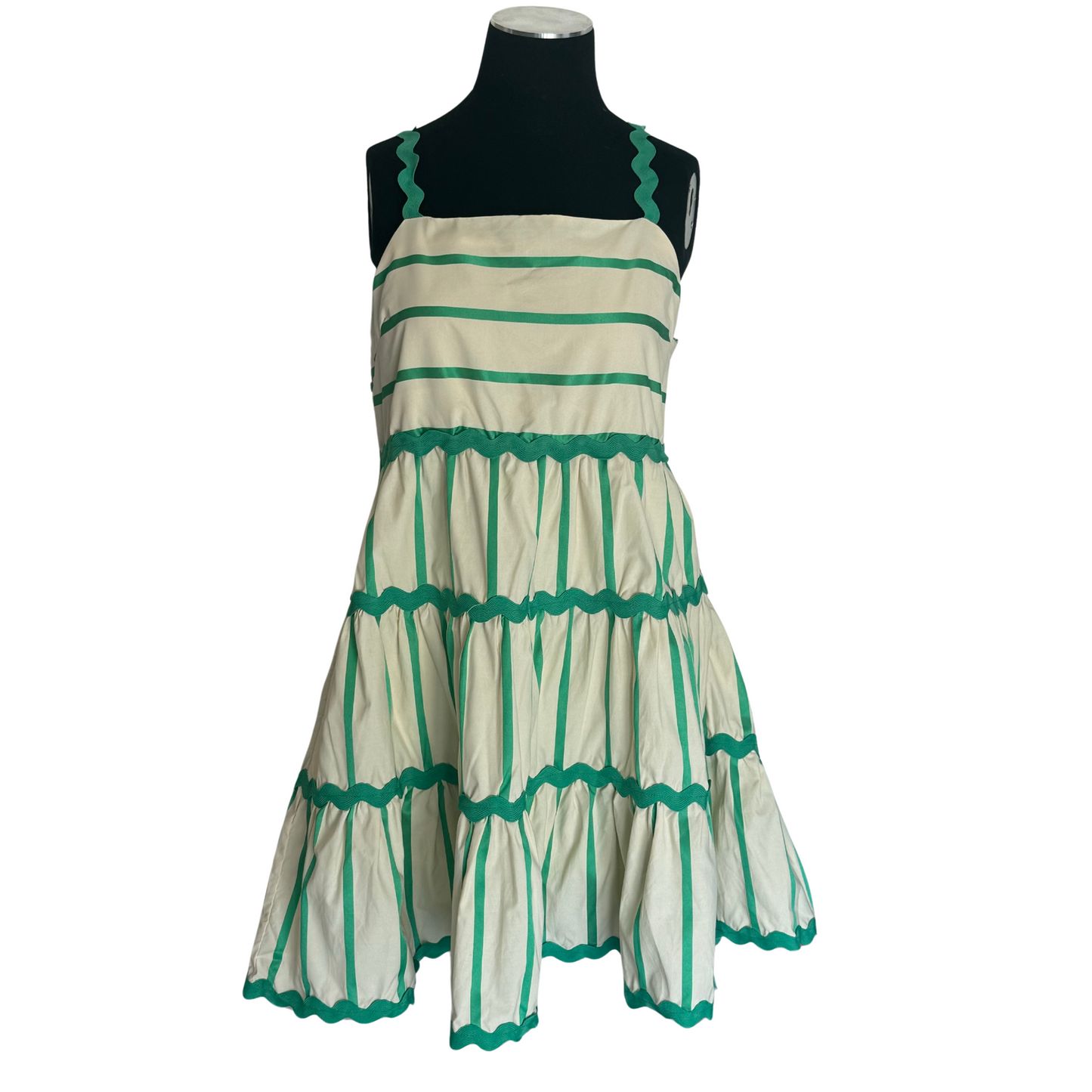 This Striped Mini Dress combines earthy green tones with natural hues, creating a stylish and versatile piece for your wardrobe. The ricrac straps and accents add a unique touch to the classic mini dress silhouette. Perfect for any occasion, this dress will make you feel confident and effortlessly chic.