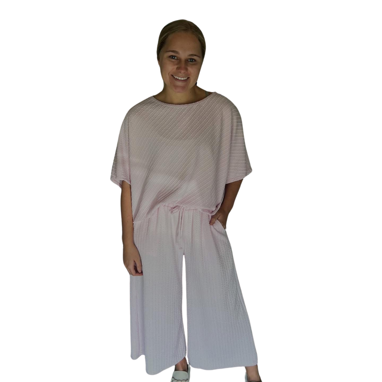 This oversized top and bottom set features a flattering scoop neck top and drawstring pants, both in a stylish and versatile lilac color. Made from a comfortable knit fabric, this set is perfect for lounging at home or running errands in style. Upgrade your wardrobe with this cozy and chic set.