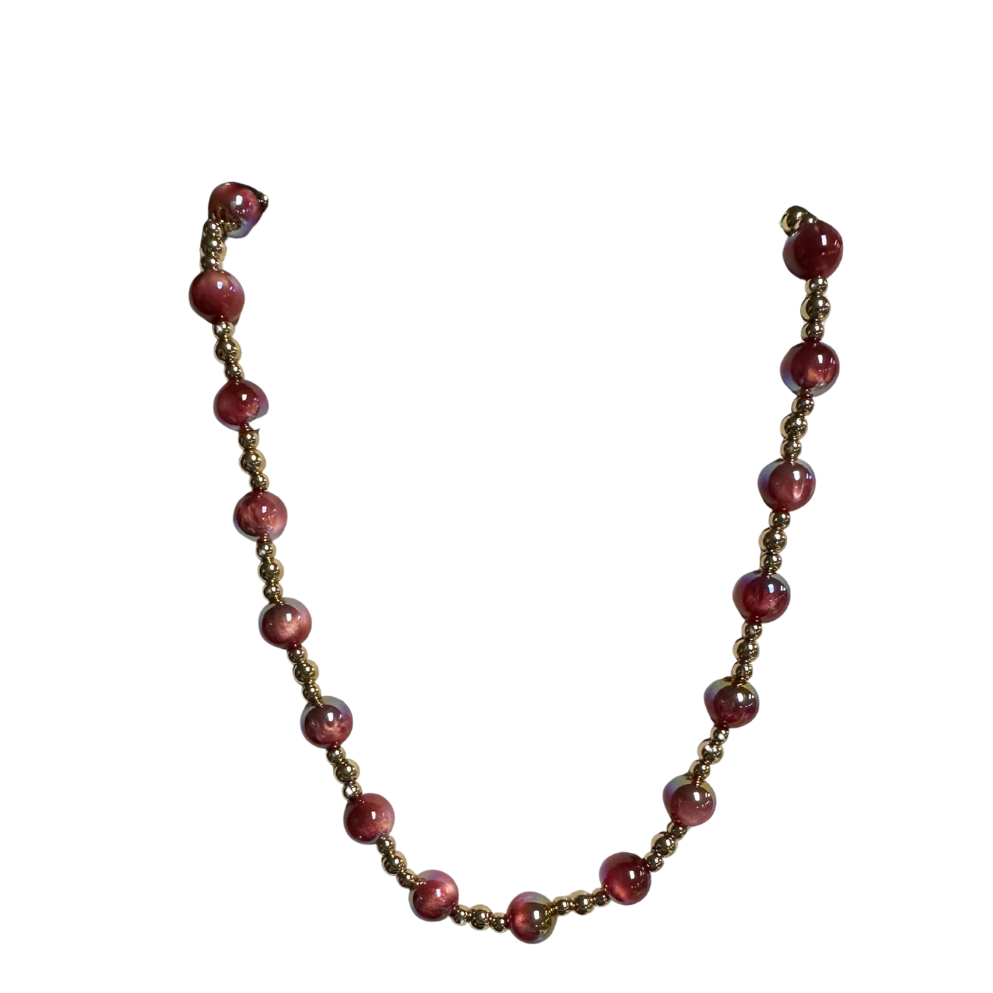 Elevate your everyday elegance with this exquisite beaded necklace from Perdido Gems. Crafted with lustrous gold-toned beads and soft pink accents, this short-length piece strikes the perfect balance between sophistication and versatility. The carefully selected beads create a refined aesthetic that complements both casual and polished looks. Ideal for layering or wearing solo, this necklace brings a touch of refined glamour to any wardrobe.