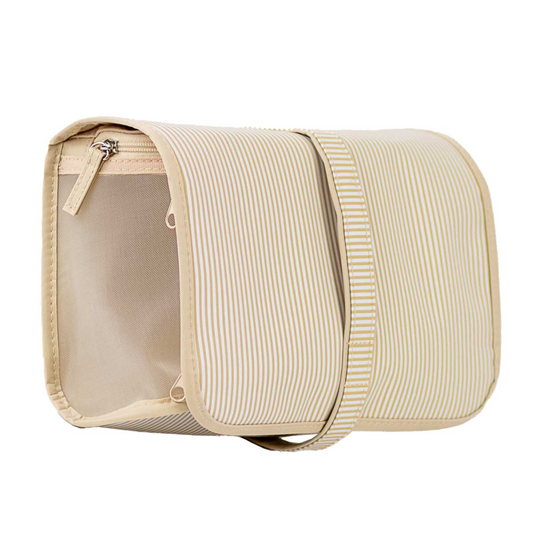 The Pinstripe Travel Cosmetic Bag by The Royal Standard combines classic beige and white pinstripe design with practical functionality. Crafted for organized storage, this bag is ideal for keeping your cosmetics secure and accessible during travel. Its durable construction ensures protection for your essentials, making it a reliable companion for any journey.