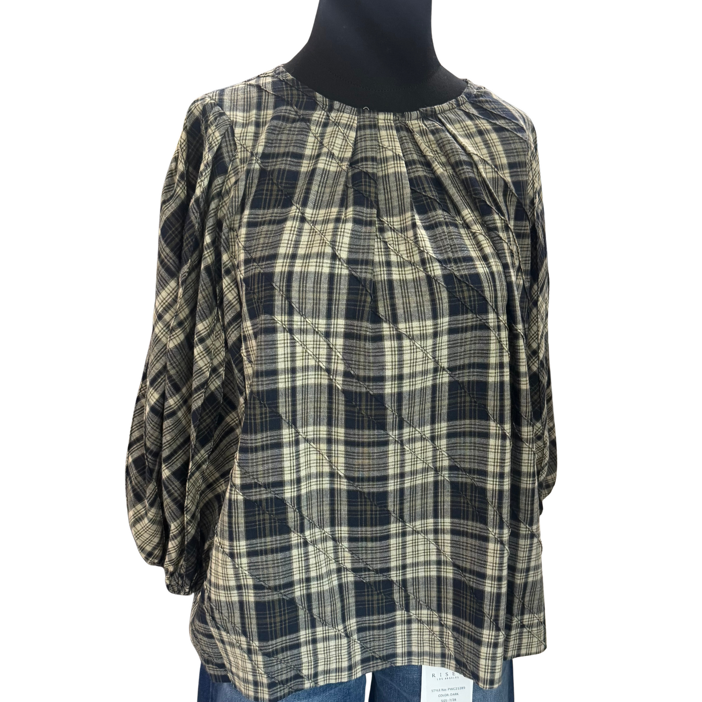 This navy plaid top from GiGio combines classic patterning with modern style, featuring pleated details that add texture and sophistication. Its 3/4 length sleeves offer a versatile fit for layering or standalone wear, making it ideal for both professional and casual settings. The tailored design provides a polished look while ensuring comfort throughout the day.