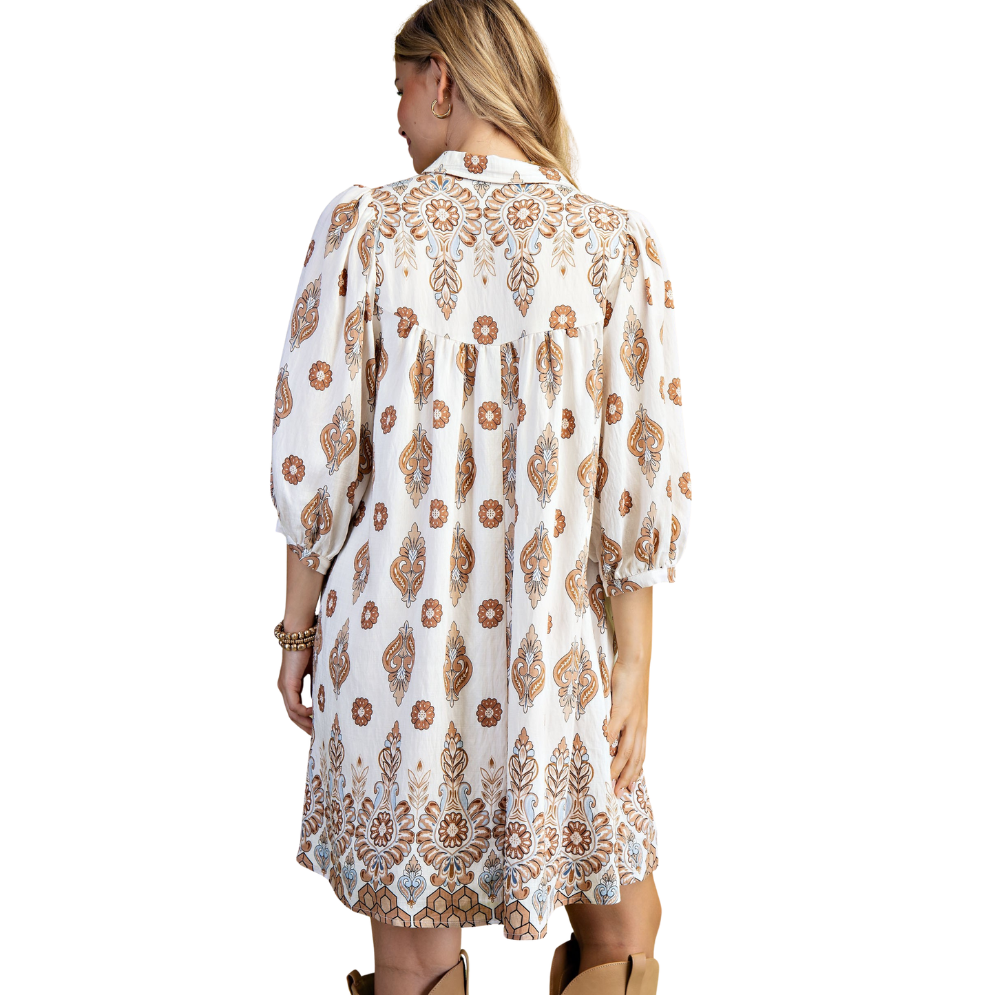 Effortless elegance meets everyday comfort in this GiGio Printed Shirt Dress. Crafted in a soft beige tone, this versatile piece features a classic button-up front and flattering 3/4 length sleeves—perfect for layering or wearing solo. The relaxed fit and printed details create a polished look that transitions seamlessly from office to weekend. A wardrobe essential that works as hard as you do.