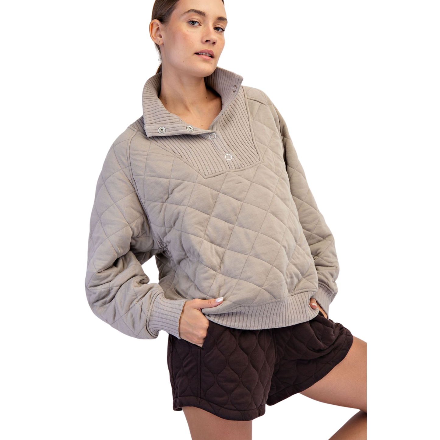 The Rae Mode Quilted Snap Pullover in taupe features a sophisticated quilted design for added texture and warmth. Equipped with convenient snap buttons, it offers easy wear and adjustable comfort. This pullover combines functional details with a refined look, making it an ideal layering piece for cooler days.