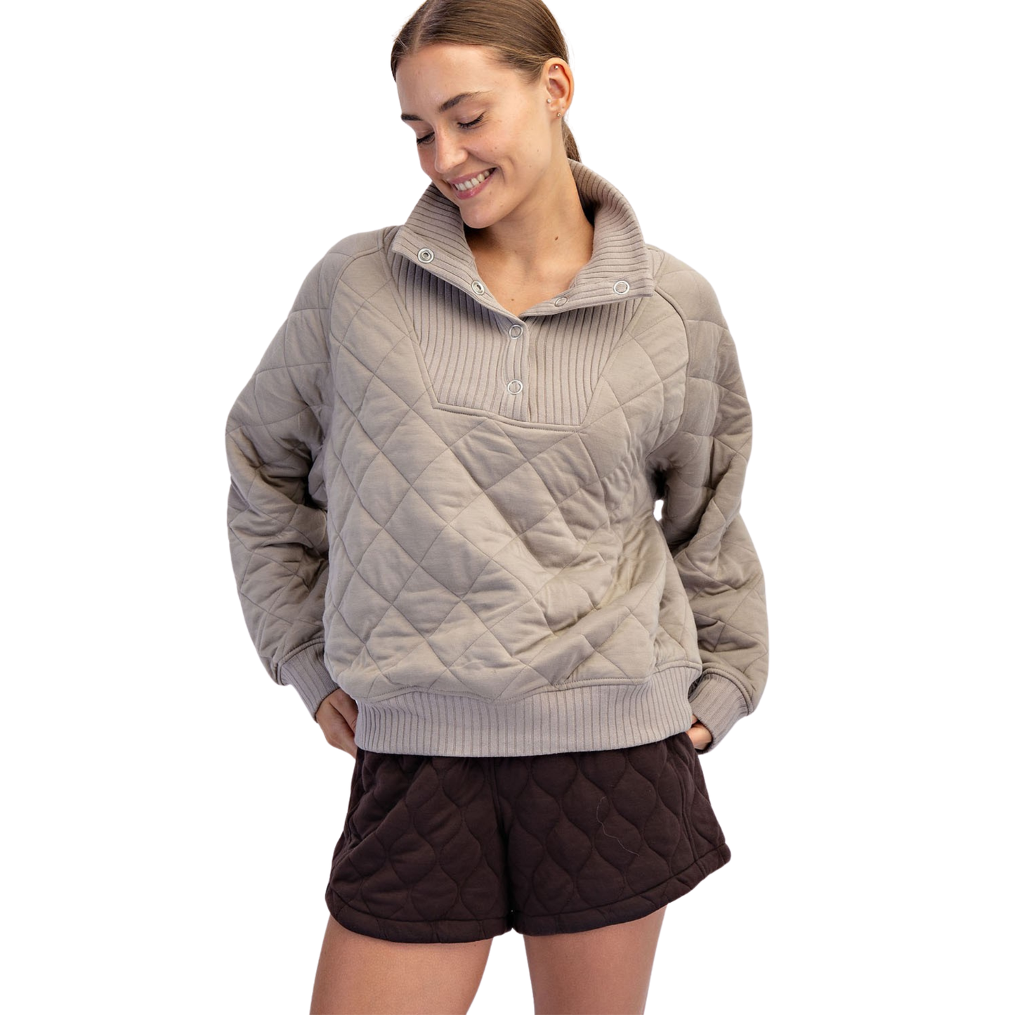 The Rae Mode Quilted Snap Pullover in taupe features a sophisticated quilted design for added texture and warmth. Equipped with convenient snap buttons, it offers easy wear and adjustable comfort. This pullover combines functional details with a refined look, making it an ideal layering piece for cooler days.