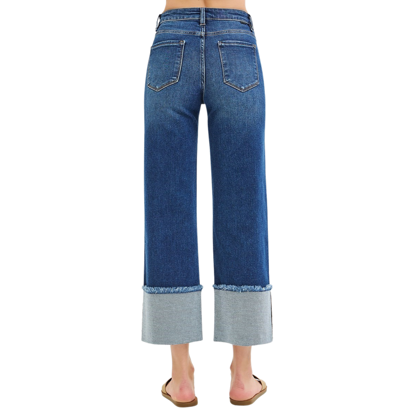 These Risen brand Mid Rise Cropped Wide Cuffed Jeans feature a dark wash and a wide leg with a wide cuff hem. Perfect for a trendy and stylish look, these jeans provide a comfortable fit and a fashionable edge. Upgrade your wardrobe with these must-have cropped jeans.