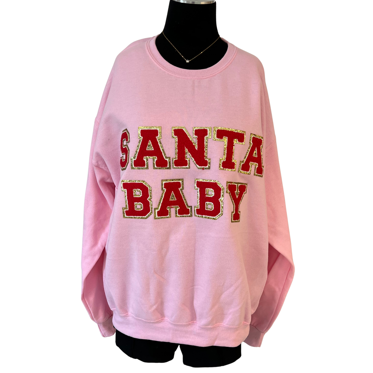 Stay cozy this holiday season in the stylish Santa Baby Sweatshirt. Crafted from soft fabric to keep you comfortable, this festive piece features a pink hue and red writing that reads "Santa Baby." Enjoy this stylish nod to the season.