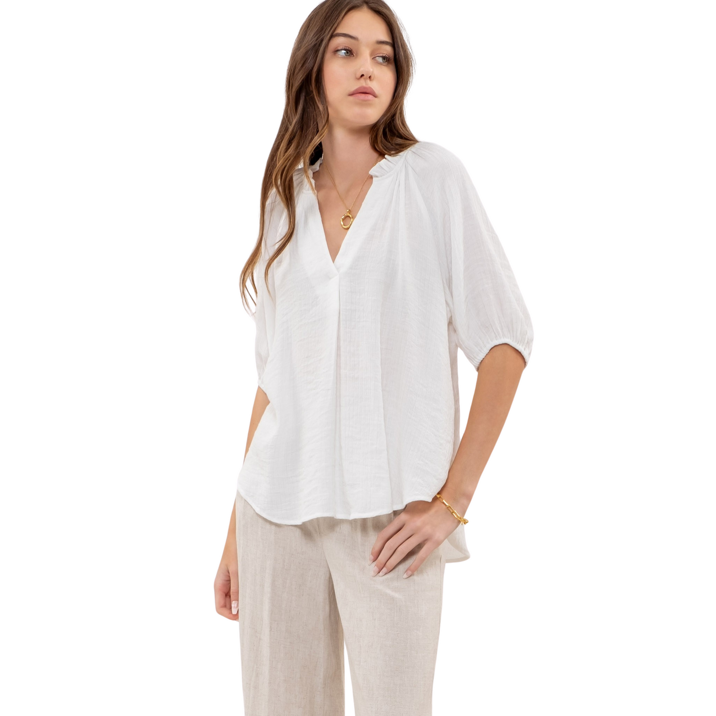 "This V-neck top features a lightweight and comfortable design, perfect for all-day wear. The flattering v-neck style is accentuated by a ruffled collar, giving this top a touch of elegance. Available in classic white, this top is a versatile addition to any wardrobe."