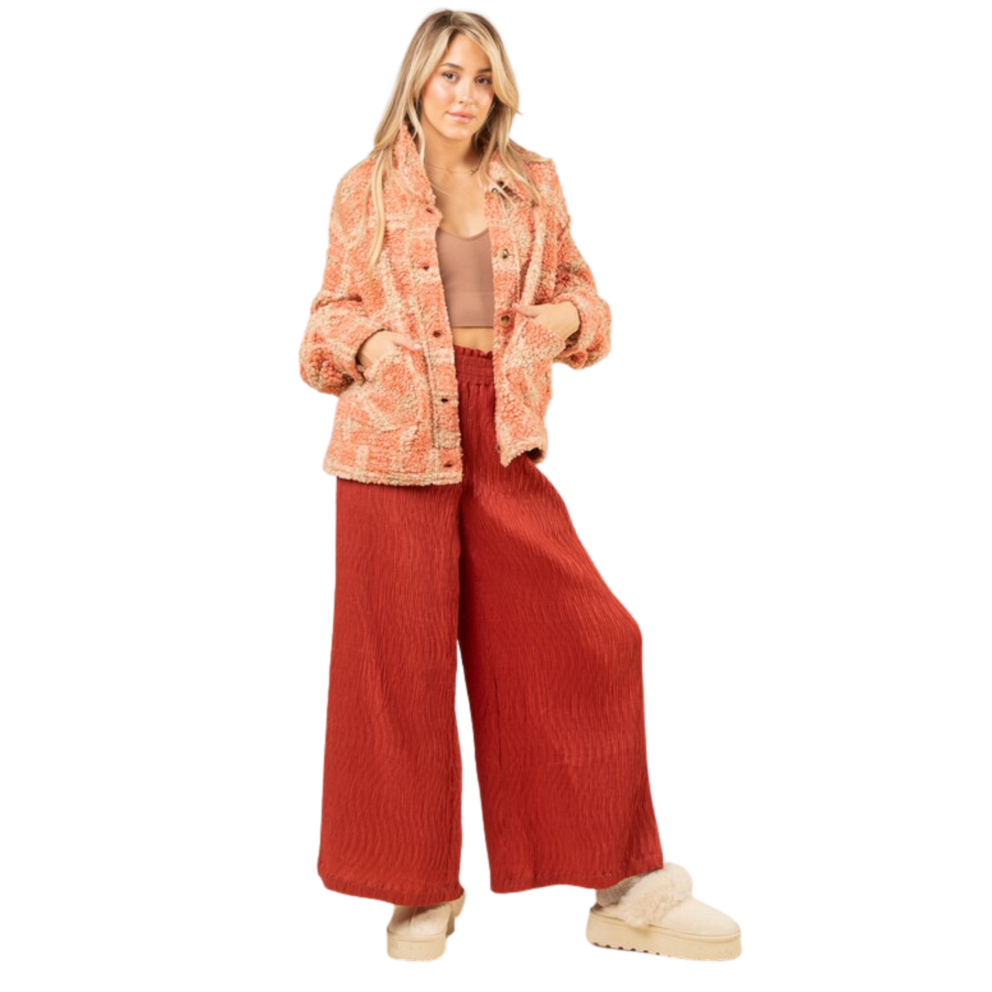 This oversized plaid shacket is perfect for combining comfort and style. It features a drop shoulder design with long sleeves, and is button-up with front pockets. The cozy sherpa material adds warmth, making this shacket a great choice for the winter months.