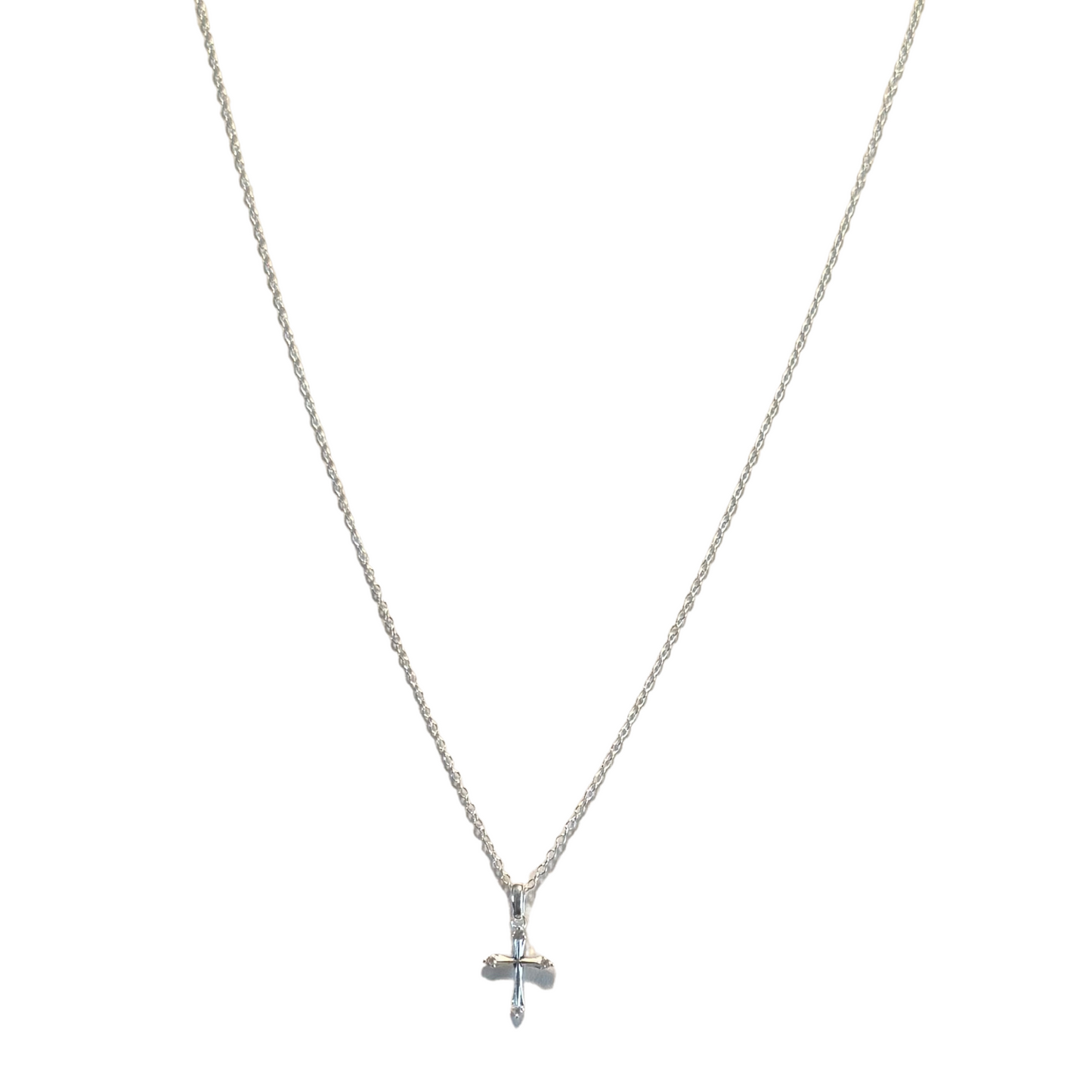 This delicate silver cross pendant by Skosh features a minimalist design on a short chain. Precision-crafted for subtle elegance, the small proportions make it ideal for everyday wear or layering with other pieces. The refined simplicity allows for versatile styling across casual and formal occasions.