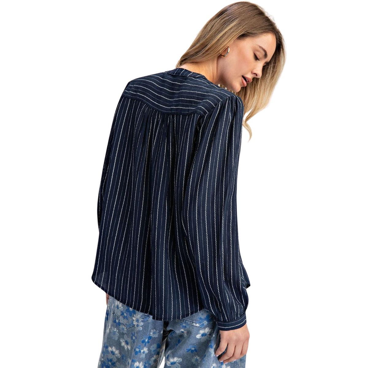 Elevate your wardrobe with this navy Cotierra button-down blouse, featuring timeless vertical stripes and a flattering smocked design. The structured smocking adds dimension and comfort, while the classic striped pattern pairs effortlessly with any bottoms. Perfect for work, weekend outings, or layering. A versatile essential that transitions seamlessly from season to season.