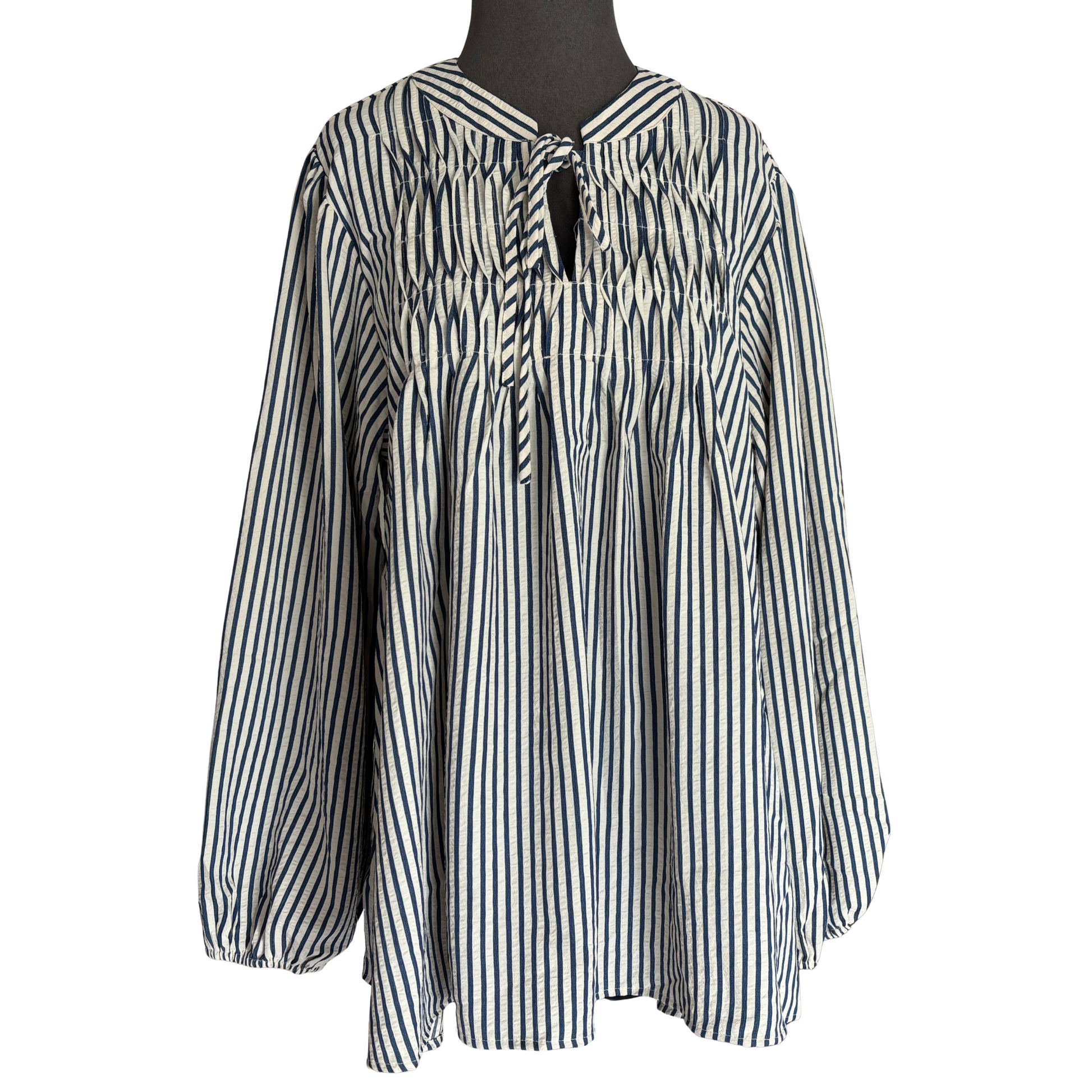 Elevate your wardrobe with the She+Sky Long Sleeve Striped Woven Top, featuring classic blue and cream stripes for a timeless look. The subtle pink tuck detail adds a refined touch of sophistication, while the long sleeves provide coverage and comfort. Crafted with quality materials, this top combines style and ease, making it a versatile piece for both casual and professional settings.