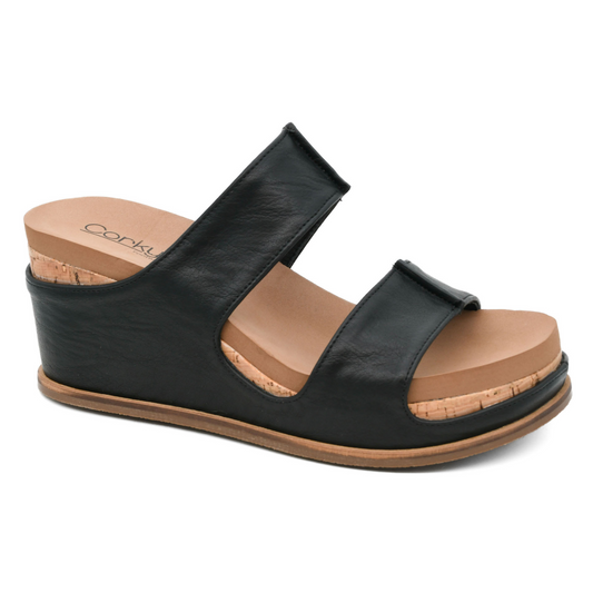 This Table For Two sandal by Corkys features a sleek black design with an open toe, perfect for any occasion. The wedge heel offers both style and comfort, making it a must-have addition to your shoe collection. Elevate your look with these elegant and versatile sandals.