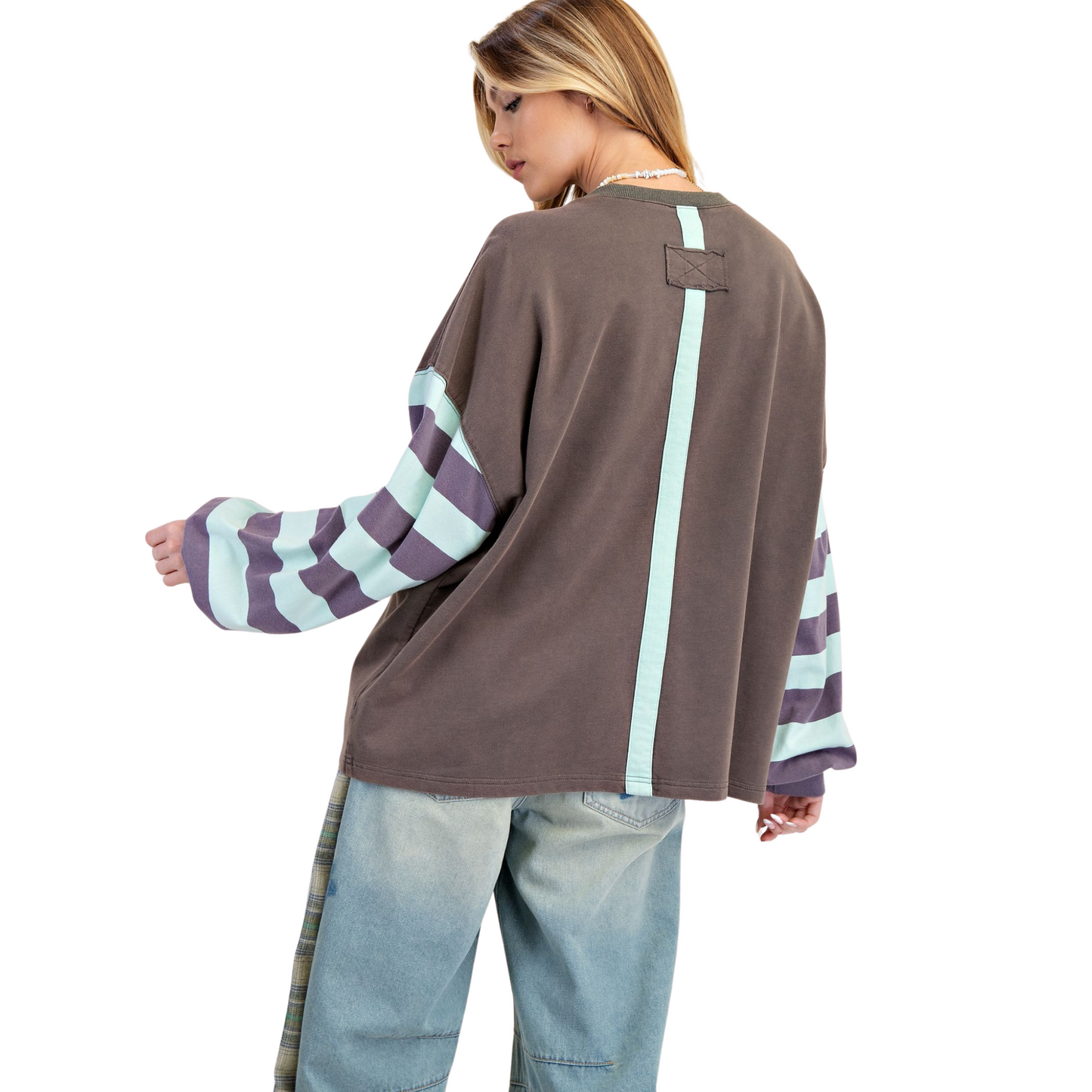 The Flower Patch Terry Knit Pullover by Easel features a refined dark grey base accented with a blue flower patch design, offering a subtle yet stylish statement. Crafted with long sleeves, this pullover combines comfort and warmth with a polished look, making it perfect for layering in cooler weather or as a standout piece on its own. Its quality knit fabric ensures durability and a gentle feel against the skin, ideal for those who appreciate blend of design and functionality in their wardrobe.