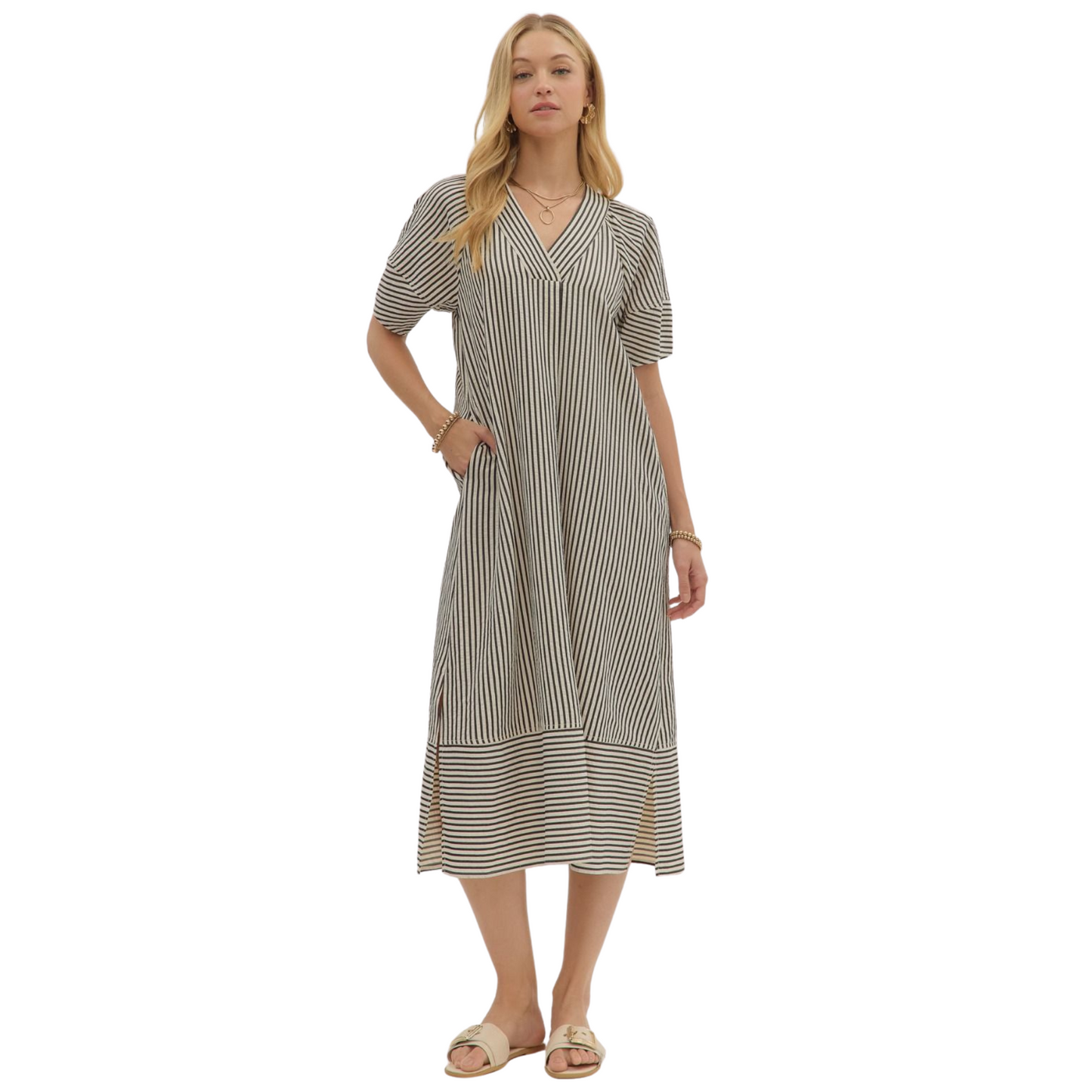 Embrace autumn elegance with the Entro black striped V-neck midi dress. Crafted for fall, its textured fabric offers subtle depth and warmth, while the flattering V-neckline and midi length provide a sophisticated silhouette. Perfect for layering or wearing alone, this dress balances comfort and style for the seasonal transition.