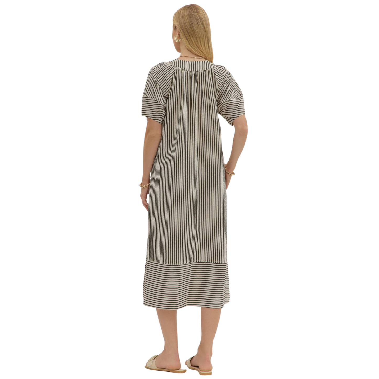 Embrace autumn elegance with the Entro black striped V-neck midi dress. Crafted for fall, its textured fabric offers subtle depth and warmth, while the flattering V-neckline and midi length provide a sophisticated silhouette. Perfect for layering or wearing alone, this dress balances comfort and style for the seasonal transition.