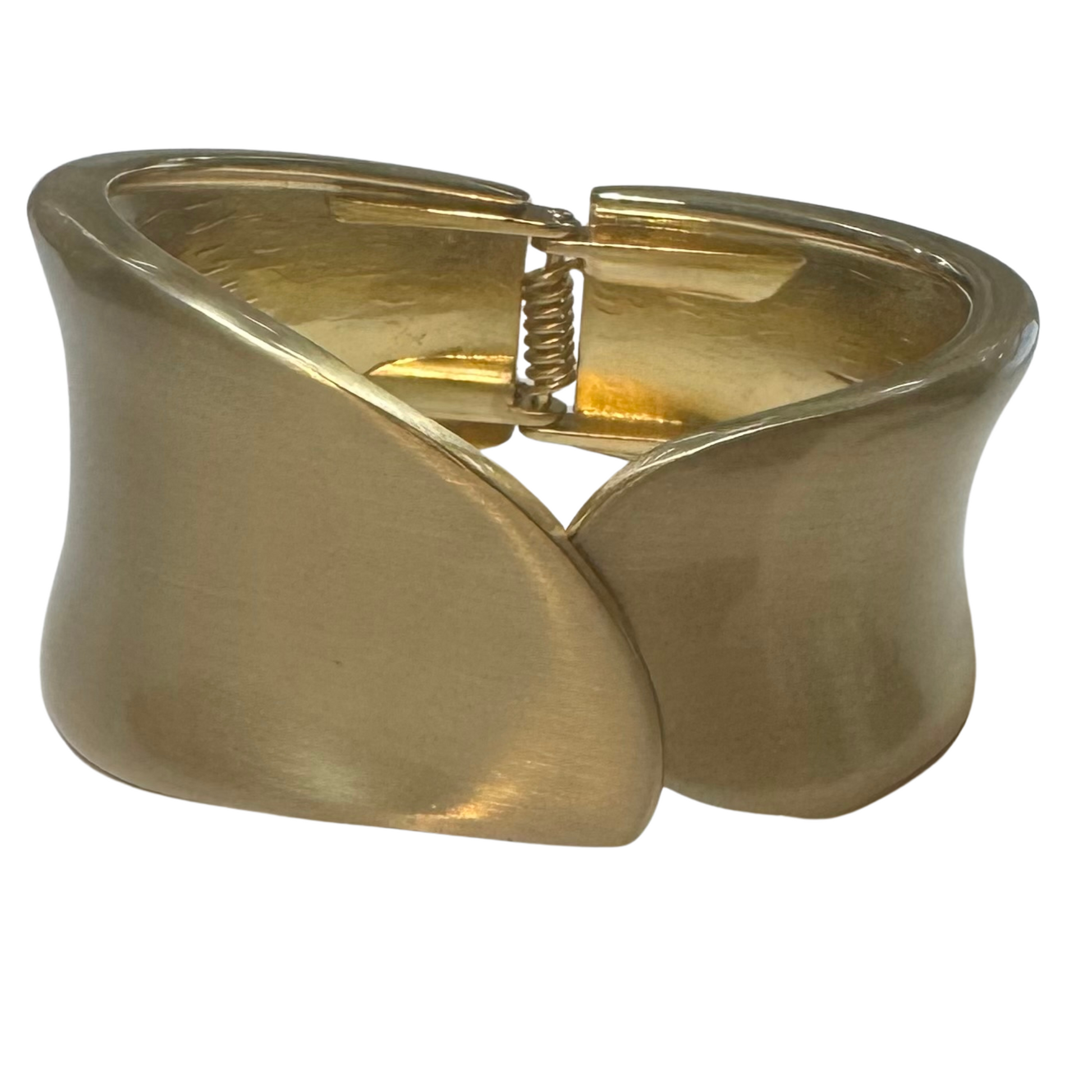 This thick cuffed bangle bracelet features a hinged design for easy wear and removal. Crafted in gold, it offers a bold yet refined statement piece that complements both casual and formal attire. Its sturdy construction ensures durability while maintaining a sleek, polished look suitable for everyday elegance.