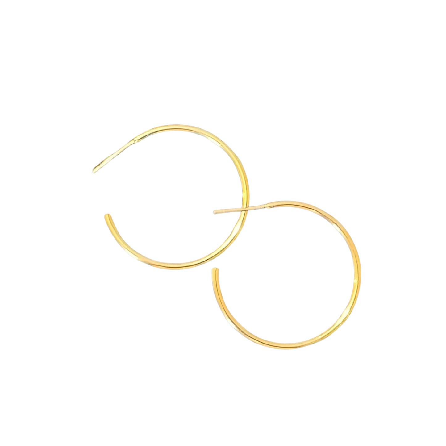 These medium hoop earrings from Perdido Gems showcase expertly designed gold construction with a delicate thin profile. The proportionate size offers substantial visual impact without excess weight, making them ideal for extended wear. Their classic circular form works harmoniously with various face shapes and personal aesthetics, while the quality gold finish resists tarnishing. A sophisticated staple that bridges casual and formal wardrobes with effortless versatility.