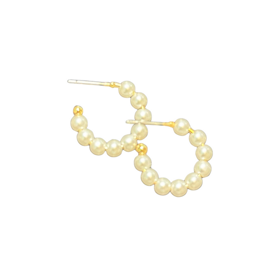 Featuring a timeless design, these Small Pearl Hoops by Ete are a must-have for every jewelry collection. The delicate hoop earrings are lined with lustrous pearls, adding a touch of elegance and sophistication to any outfit. Upgrade your style with these stunning hoops.