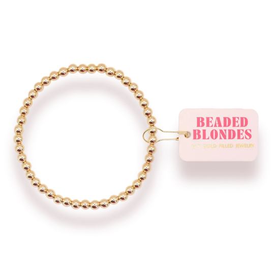 Elevate your everyday style with this stunning 4mm Beaded Bracelet from Beaded Blondes. Crafted with lustrous gold beads, this stretchy bracelet offers effortless comfort and versatility. The delicate beads catch the light beautifully, adding a touch of elegance to any outfit. Perfect for layering or wearing solo, this timeless piece transitions seamlessly from day to night. The stretchy design ensures a comfortable fit for all wrist sizes, making it an ideal accessory for any occasion.