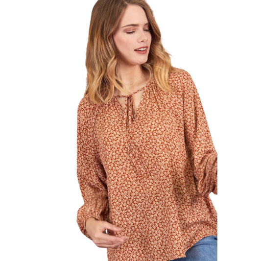 Get ready to turn heads in our Floral Print Tie Front Top. This plus-size top features an all-over print, long sleeves, and a flattering tie front. The lightweight fabric has a beautiful burnt orange color that's perfect for any season. Make a statement while staying comfortable!