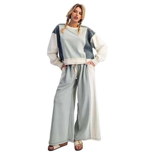This set features a sophisticated blend of blue shades in a color-block design, combining a long sleeve top with denim-colored drawstring pants. The top’s varied blue tones enhance visual interest while providing comfortable coverage, and the adjustable drawstring pants ensure a perfect fit with casual ease. Ideal for those seeking a stylish yet relaxed outfit that balances modern design with everyday comfort.