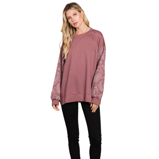 This French Terry Printed Sleeve Top features paisley print sleeves for a unique, stylish look. The dark mauve color offers versatile wear, and the sweatshirt-style material provides a comfortable, cozy fit. Perfect for cooler weather dressing with a chic edge.