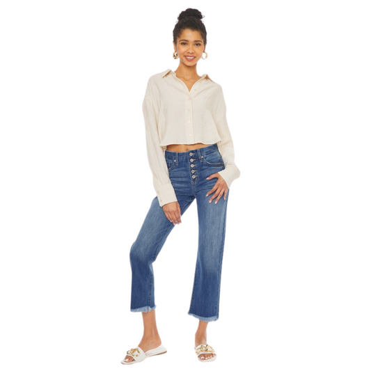 These High Rise Botton Fly Straight Leg Jeans feature a cropped, raw hem and a medium wash, creating a versatile piece to take you from day to night. The high rise fit, and straight leg make it a timeless classic.