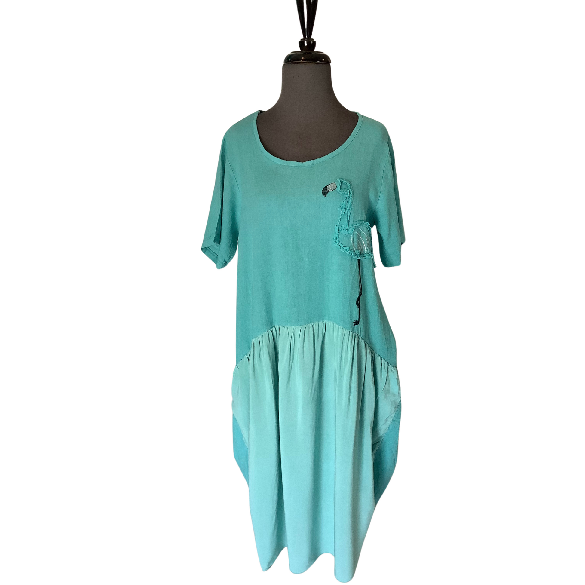 Our classic linens mixed with Flamingo design offer a unique and stylish look. This elegant dress features a maxi length with a gorgeous seafoam color and chic scoop neck. The short sleeves make this a perfect summer dress.