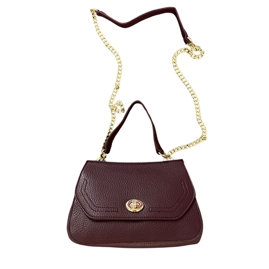 The Lottie Lockig Purse by Jen &amp; Co. is a compact, burgundy accessory designed for secure, stylish convenience. Featuring a reliable lock mechanism, it ensures your essentials stay safe while on the go. Its long strap offers versatile carrying options, making it ideal for hands-free use. Perfectly sized for everyday essentials, this small purse combines functionality with expert craftsmanship.