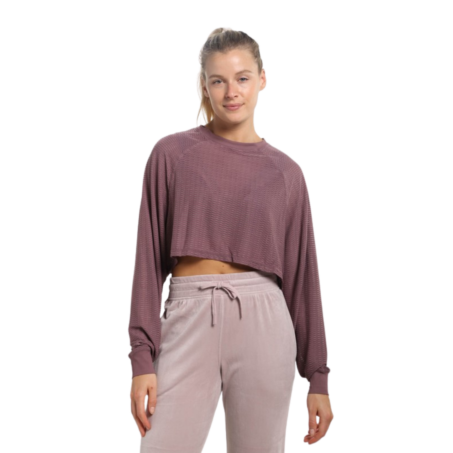 Our Mesh Raglan Cropped Top is a stylish addition to any wardrobe. This top comes in a cool sea green or mauve color with a cropped length and long sleeves. The breathable mesh fabric ensures all-day comfort.