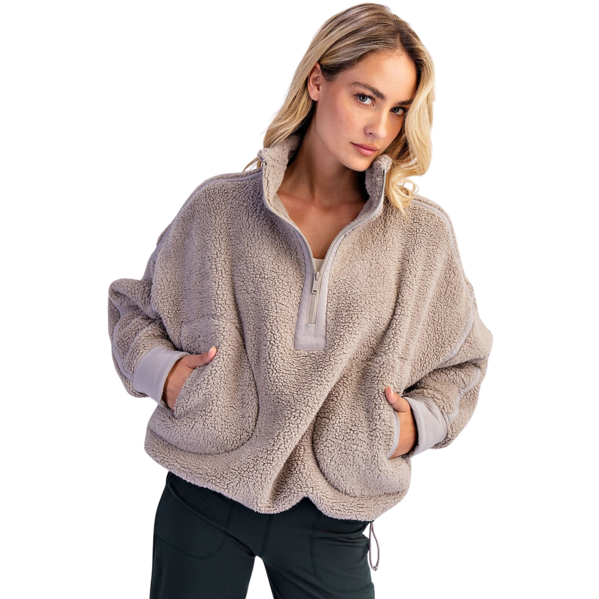 Experience ultimate warmth and style with the Rae Mode Mock Neck Sherpa Jacket. Crafted in a versatile taupe shade, this quarter-zip pullover features plush sherpa fabric that provides exceptional comfort and insulation. Its mock neck design offers added protection against chilly winds, making it ideal for layering in colder weather. Perfect for both casual outings and outdoor adventures, this jacket combines cozy softness with functional style for reliable all-day wear.